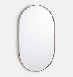 an oval mirror hanging on the wall