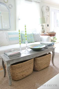 a living room filled with lots of furniture and decor on top of a rug next to a window