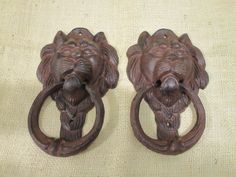 two lion head door handles on a beige background