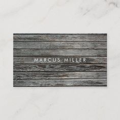 wood grain business card with the word marcus miller in white lettering on top of it