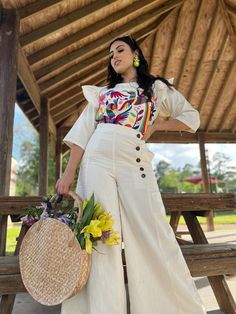 This modern style Two Piece Jumpsuit with a traditional Mexican look is the perfect outfit to add to your wardrobe. Its otomi embroidery makes it unique and spectacular. This outfit is made with love by Mexican Artisans in Oaxaca, Mexico. Each piece is unique, you can see some variation in the embroidery. Processing time: 1 month approx Mexican Themed Outfit Women, Mexican Modern Fashion, Mexican Modern Outfits, Fiesta Theme Outfits Women, Hispanic Heritage Outfit Ideas, Mexican Fashion Traditional, Mexican Women Fashion, Oaxaca Fashion, Charro Outfits For Women