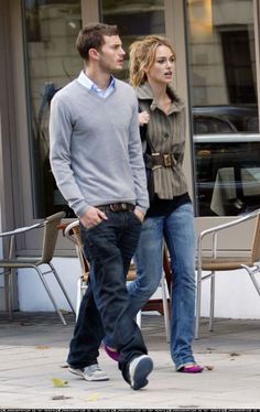 a man and woman walking down the street