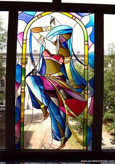 a colorful stained glass window with a woman in it's body on the outside