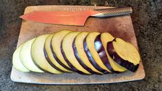 sliced up apples on a cutting board with a knife