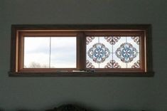 two windows with decorative designs on them in a room