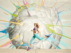 a woman is running in front of a painting