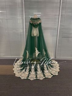 a green and white wedding dress on display