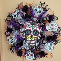 a colorful wreath with skulls and flowers on it