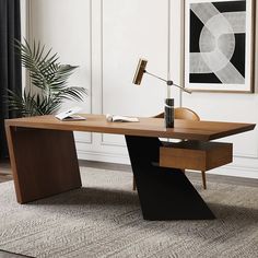 a desk with a lamp on it in front of a painting and potted plant