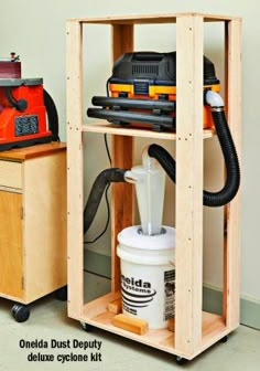 a workbench with tools in it and a sander on the floor next to it