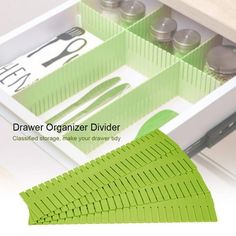 the drawer organizer divider is organized with scissors and other kitchen utensils in it