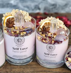 three candles sitting next to each other on top of a wooden table filled with food