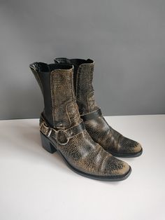 from the Miu Miu fall 2001 collection, a pair of chelsea ankle boots, engineer/motorcycle style, with removable buckle straps that can be made into a matching belt.  size 7.5 / euro 38 / uk 5 and true to size--medium or wide.  heel is 2.5", height is almost 10"  details: chelsea boots with elastic panel.  insanely great black and tan crackle/distressed leather. Prada was the first to kick off this y2k trend.  long almond toe blocky heel belt straps have solid rings and can be worn on or off.  le Leather Mid-calf Boots With Reinforced Heel, Vintage Leather Mid-calf Boots, Vintage Leather Mid-calf High Ankle Boots, Leather Mid-calf Boots With High Heel And Buckle Closure, Edgy Leather Mid-calf Boots With Zipper Closure, Long Almond, Boots Chelsea, Engineer Boots, Chelsea Ankle Boots