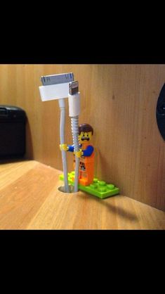 a lego man standing next to a toothbrush holder