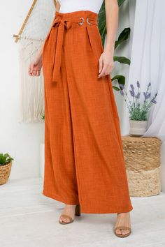 You will absolutely love this woman's versatile wide-leg high-waist pants. Perfect when paired with heels, flats, and much more. Model is wearing a Small - L: 43" W: 28" I.S.: 31" 100% polyester Color is rust orange High waist No stretch Metal details Wide leg Sequin Pant, Bow Crop Tops, Cream Crop Top, Asymmetric Jacket, Wide Trousers, Pants Large, Cotton Coat, Rust Orange, Lace Midi