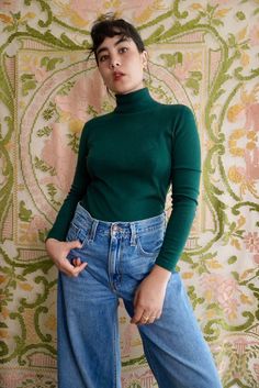 "Forest green turtleneck sweater by Modern Ms. This knit is lightweight and stretchy, semi-sheer when pulled taut. No fiber content labels, based on texture and appearance it is most likely acrylic. Pull over style with no closures or fastenings.  Size XS-S. 32\" chest, 30\" waist, 22.5\" long. 1970's." Green Fitted Casual Sweater, Fitted Fine Knit Turtleneck, Fitted Fine Knit High Neck Turtleneck, Fitted Green Fine Knit Sweater, Fitted Fine Knit Turtleneck Sweater, Casual Stretch Fine Knit Turtleneck, Spring Turtleneck Sweater, Fitted Knit Turtleneck In Solid Color, Fitted Solid Knit Turtleneck