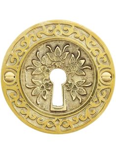 an ornate brass door knob with a keyhole on the front and side, decorated with flowers