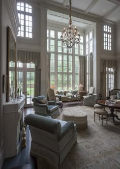 a living room filled with lots of furniture and windows