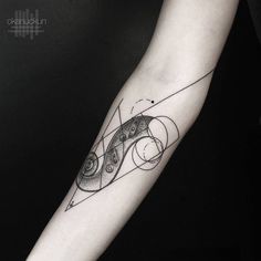 a black and white photo of a tattoo on the arm