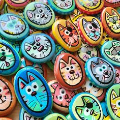 there are many colorful buttons with cats on them in the shape of faces and eyes