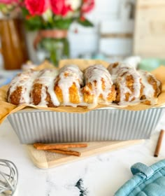 cinnamon bundts with icing sitting on top of a pan