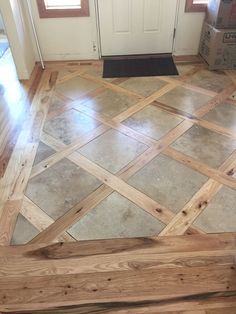 a wooden floor in front of a door with boxes on the ground next to it