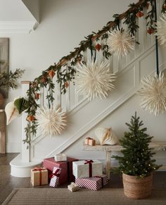 christmas decorations and presents under the banister