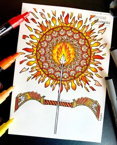 a drawing of a sunflower with an arrow in the center surrounded by crayons