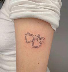 a woman's arm with a tattoo on it that says love and two hearts