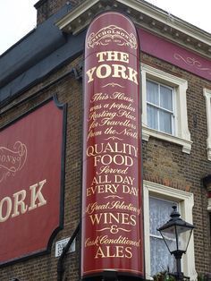 a large sign on the side of a building that says, the york quality food every day wines and ales