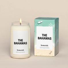 a candle sitting next to a box with the words, the bananas on it and a single lit candle in front of it