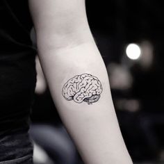 a woman's arm with a small tattoo of a brain on it