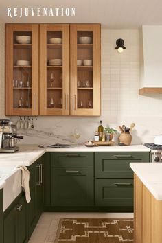 a kitchen with green cabinets and white counter tops