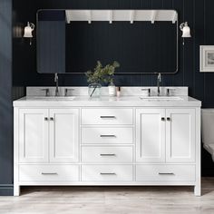 a bathroom vanity with two sinks and a large mirror above it, against a dark blue wall