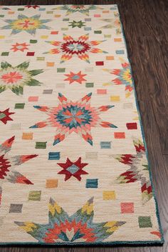 a multicolored area rug with stars on the top and bottom in different colors