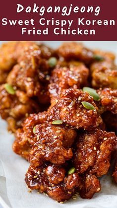 fried chicken with sauce and sesame seeds on top, served in a white bowl over rice paper