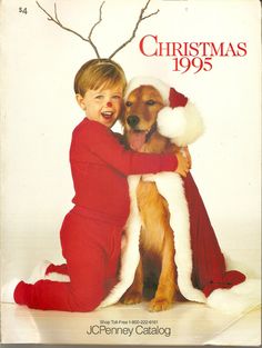 a young boy hugging a dog in front of a christmas card