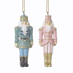 two christmas ornaments hanging from chains on a white background, one in pink and the other in blue