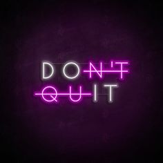 the words don't quit out are lit up in purple and pink neon lights