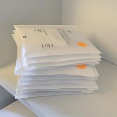 a stack of white envelopes sitting on top of each other