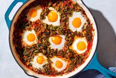 eggs are arranged in the middle of an egg dish on top of a blue skillet