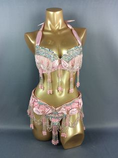 a mannequin with pink and blue beads on it's chest, wearing a bra