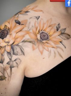 a woman's chest with sunflowers painted on it