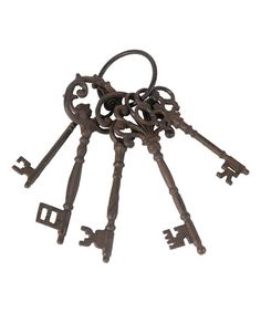 an assortment of antique keys on a white background