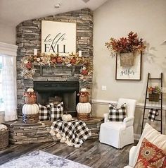 a living room filled with furniture and a fire place covered in pumpkins, greenery and fall decorations