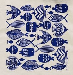 a blue and white painting of fish on a canvas tote bag, with the image of several different types of fish in it