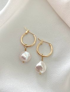 **Each piece in my shop, I personally create and photograph. (All photos are property of The Cord Gallery LLC) Thank you for supporting my small business.Dainty Gold Filled Hoop Earrings with Pearl CharmsThese beauties feature 14k Gold Filled hoop earrings adorned with genuine pearl charms. Pearl charms are removable so these are a 2 in 1 set. All components are gold filled. You will receive one pair of earrings (2 earrings)•Hoops are Gold Filled and measure 14mm Luxury Pearl Charm Earrings For Everyday Elegance, Handmade Minimalist Pearl Earrings For Everyday, Minimalist Handmade Pearl Earrings For Everyday, Minimalist Pearl Charm Hoop Earrings, Modern Pearl Jewelry, Earrings Hoops, 2 Earrings, Gold Filled Hoops, Jewelry Minimalist