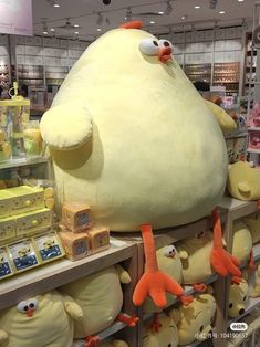 a large stuffed animal sitting on top of a shelf in a store