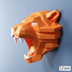 an orange paper sculpture of a tiger's head with its mouth open on a blue background