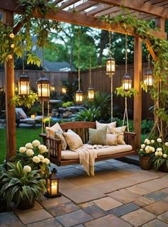 a wooden bench sitting under a pergoline covered arbor with hanging lanterns and potted plants